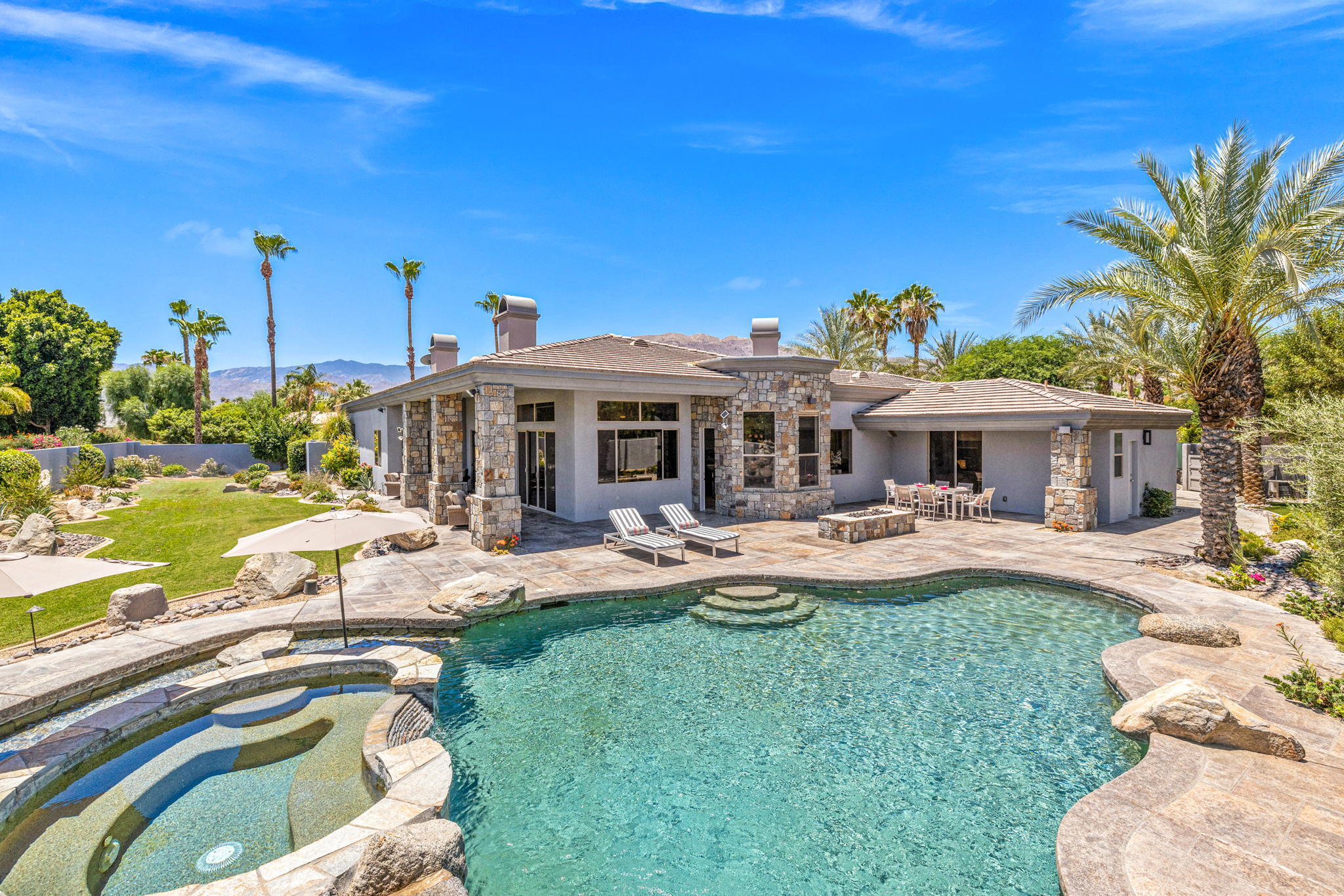 a view of a house with swimming pool and sitting area