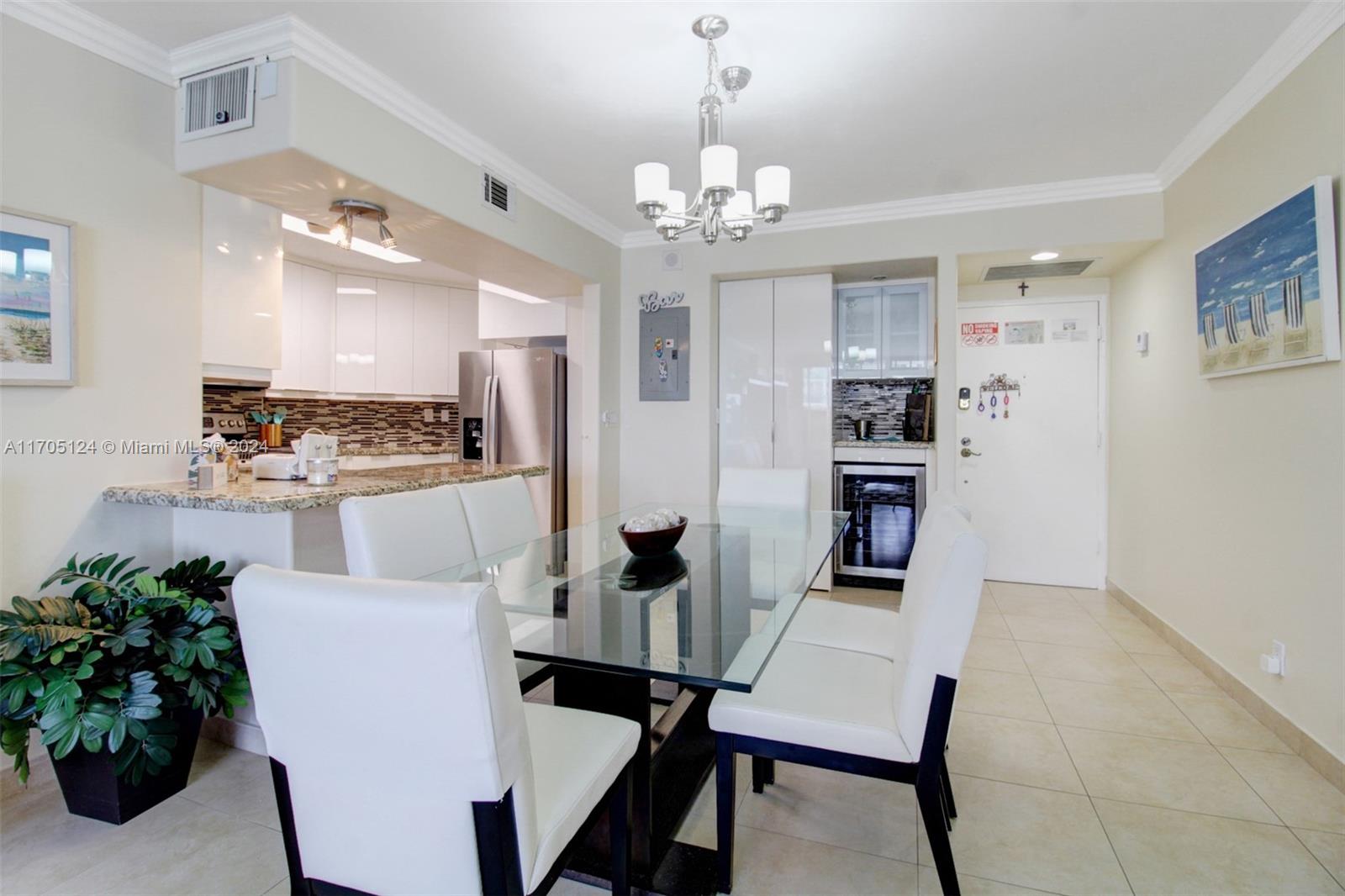 a view of a dining room with furniture and a chandelier