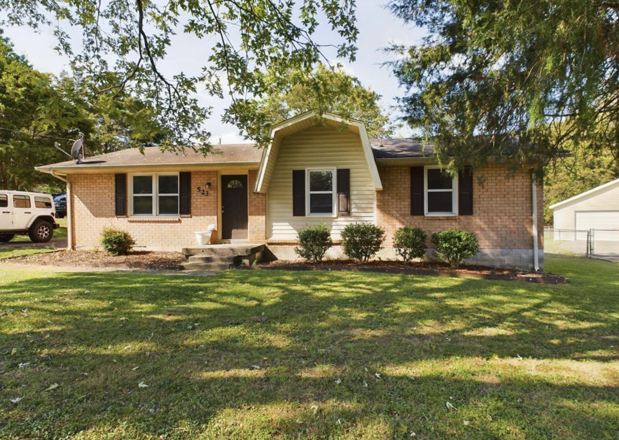 a front view of house with yard and green space