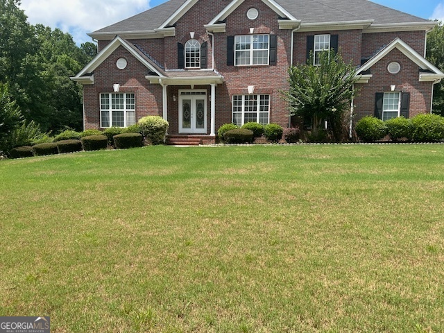 a front view of a house with garden