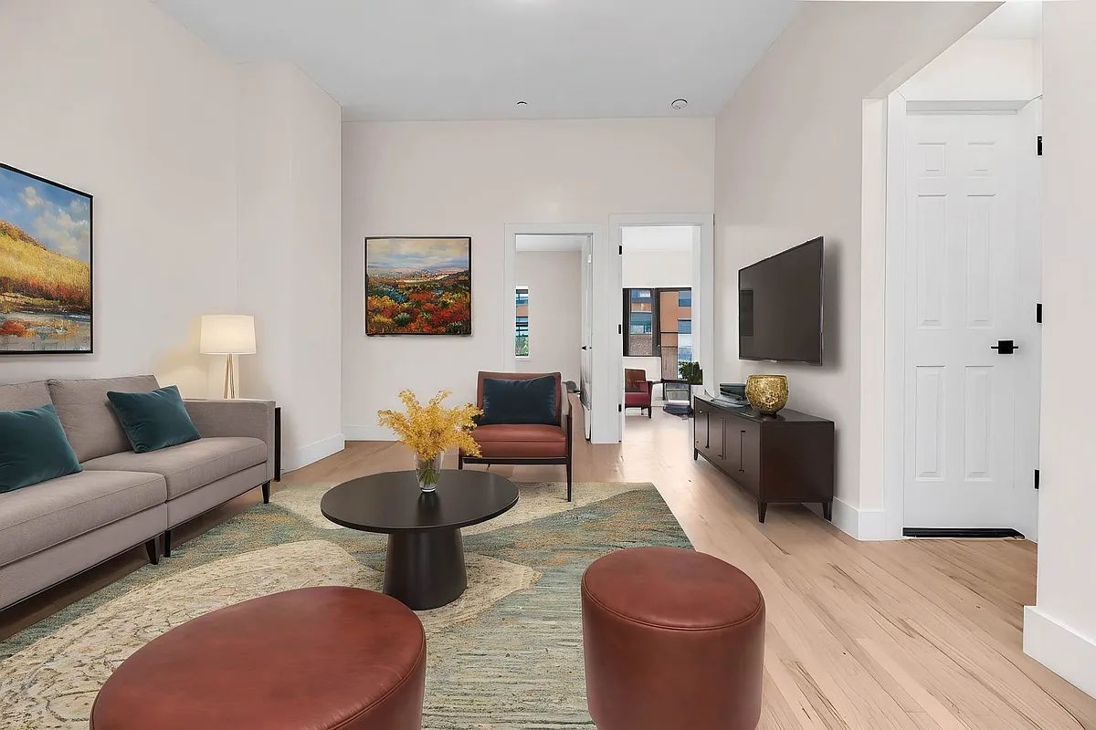 a living room with furniture a rug and a flat screen tv