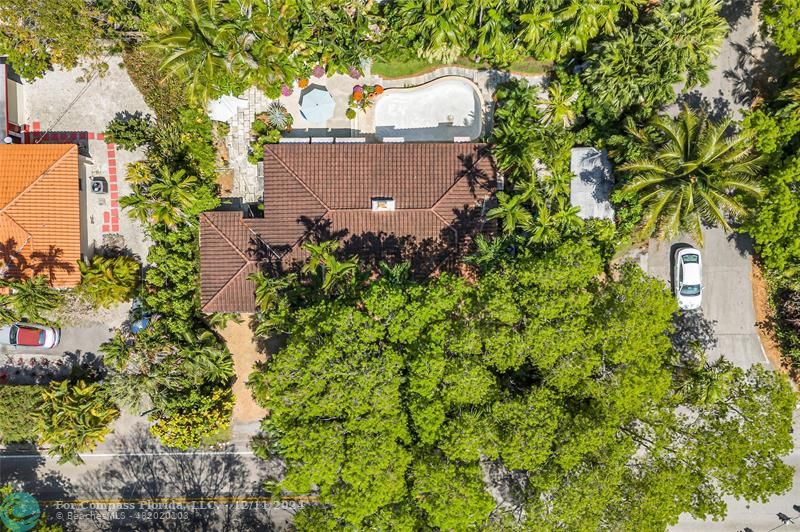 an aerial view of a house with a yard and garden