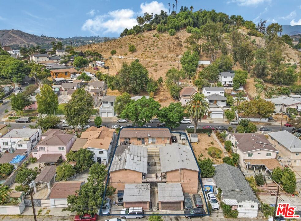 an aerial view of residential houses with outdoor space