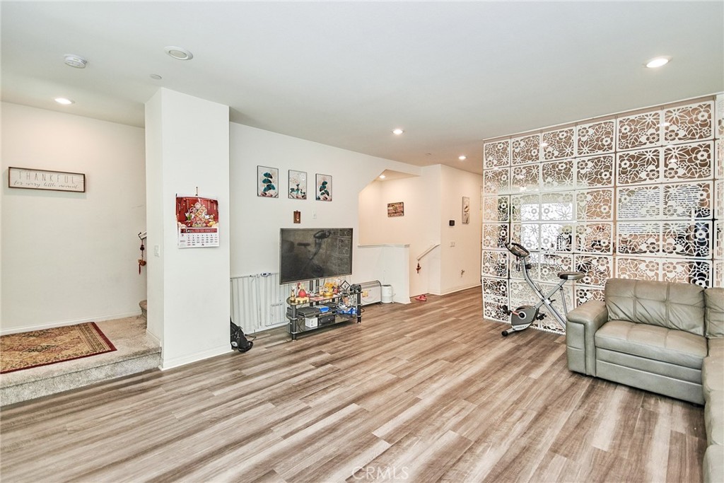 a view of a livingroom with furniture and a flat screen tv