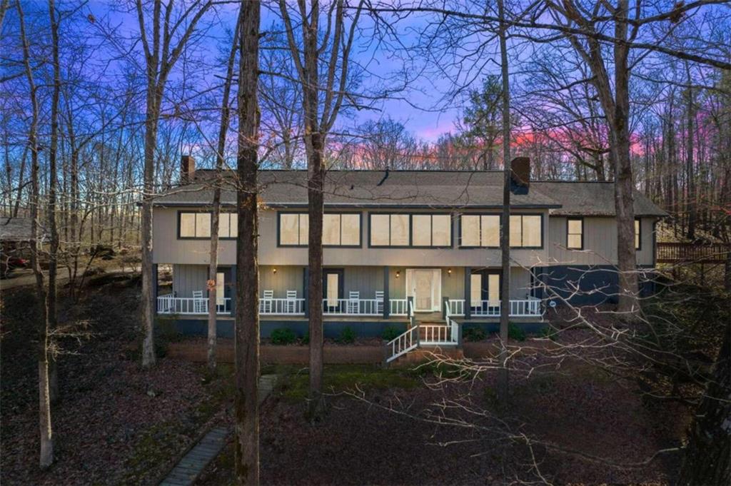 a view of backyard with deck and outdoor seating