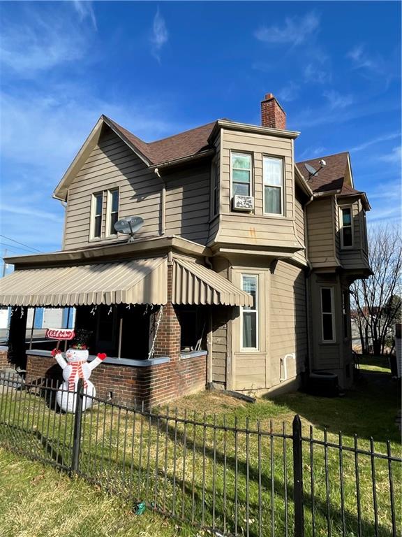 a front view of house with yard and seating area