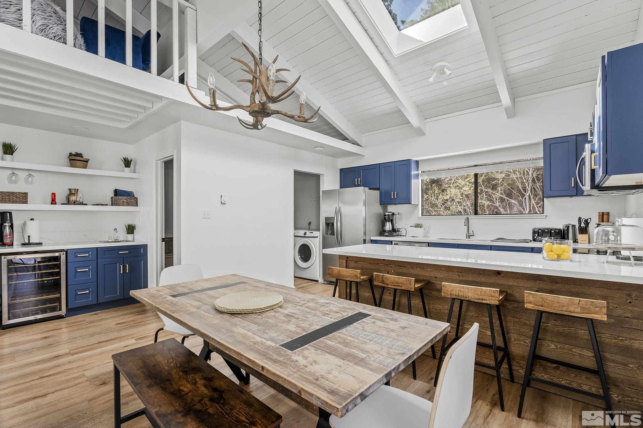 a large kitchen with a table and chairs in it