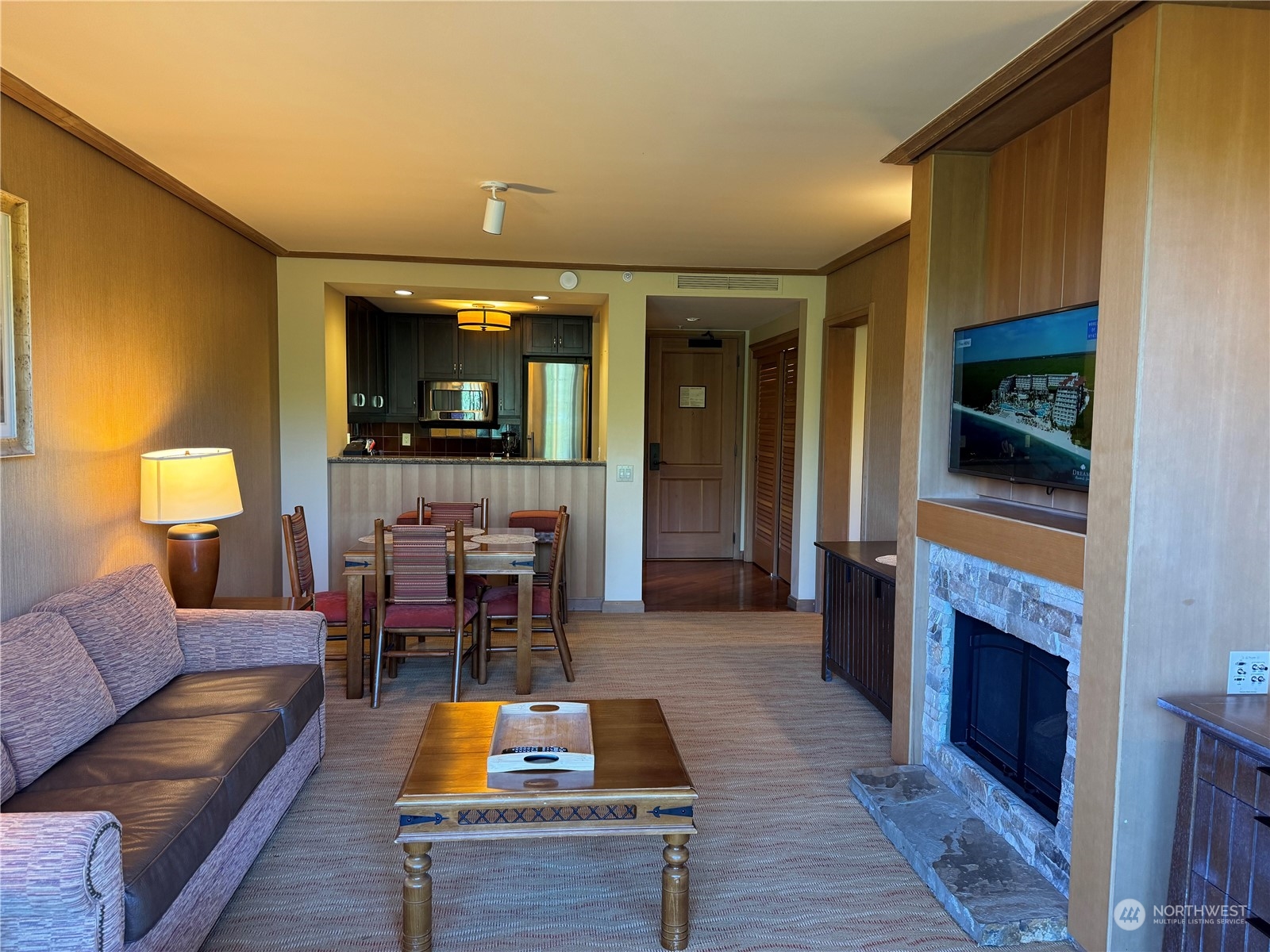 a living room with furniture a fireplace and a flat screen tv