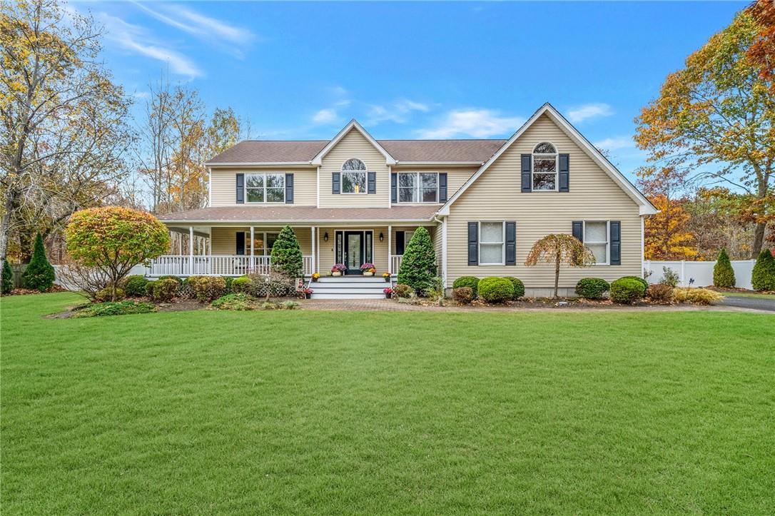 View of front of property featuring a porch and a front lawn