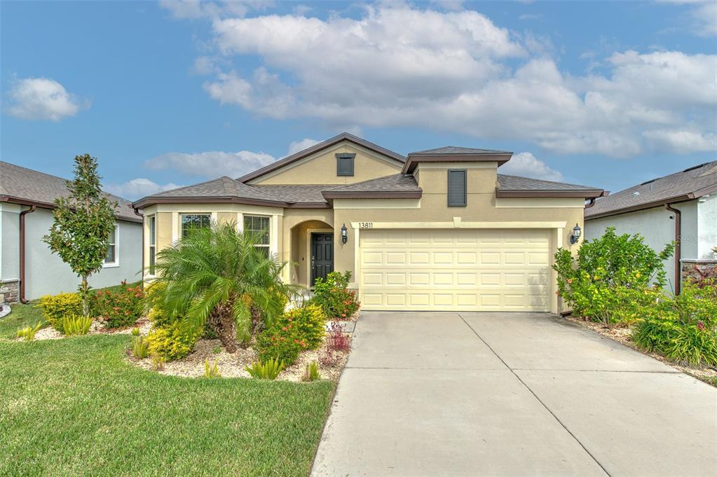 a front view of a house with a yard and garage