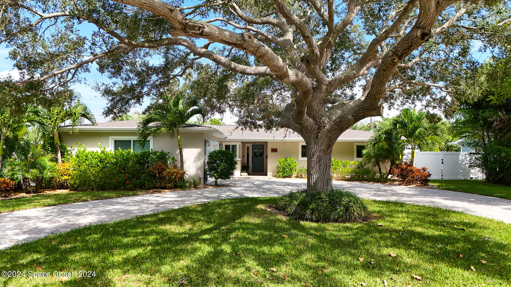 a front view of a house with yard and green space