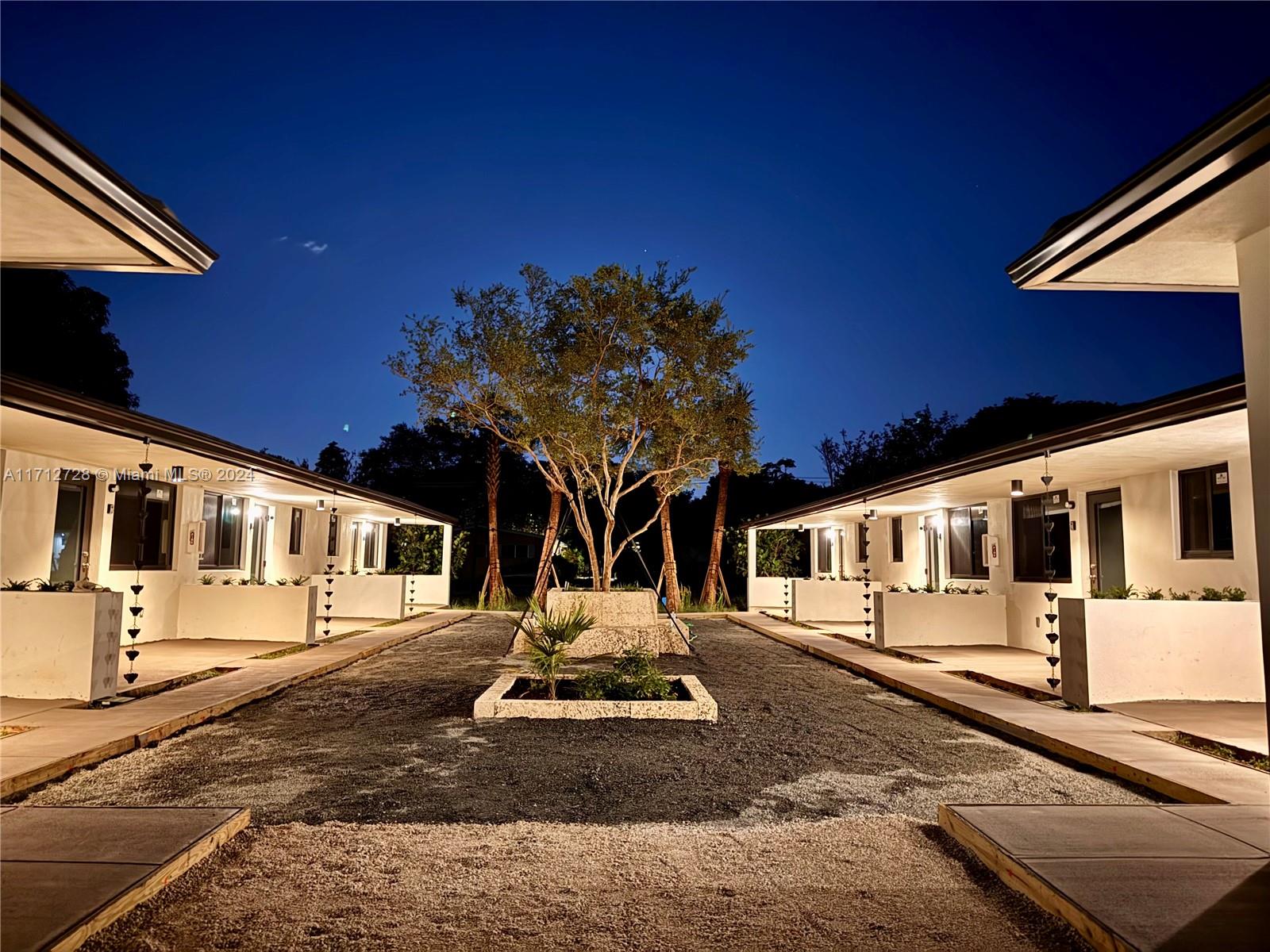 a front view of a house with sitting area