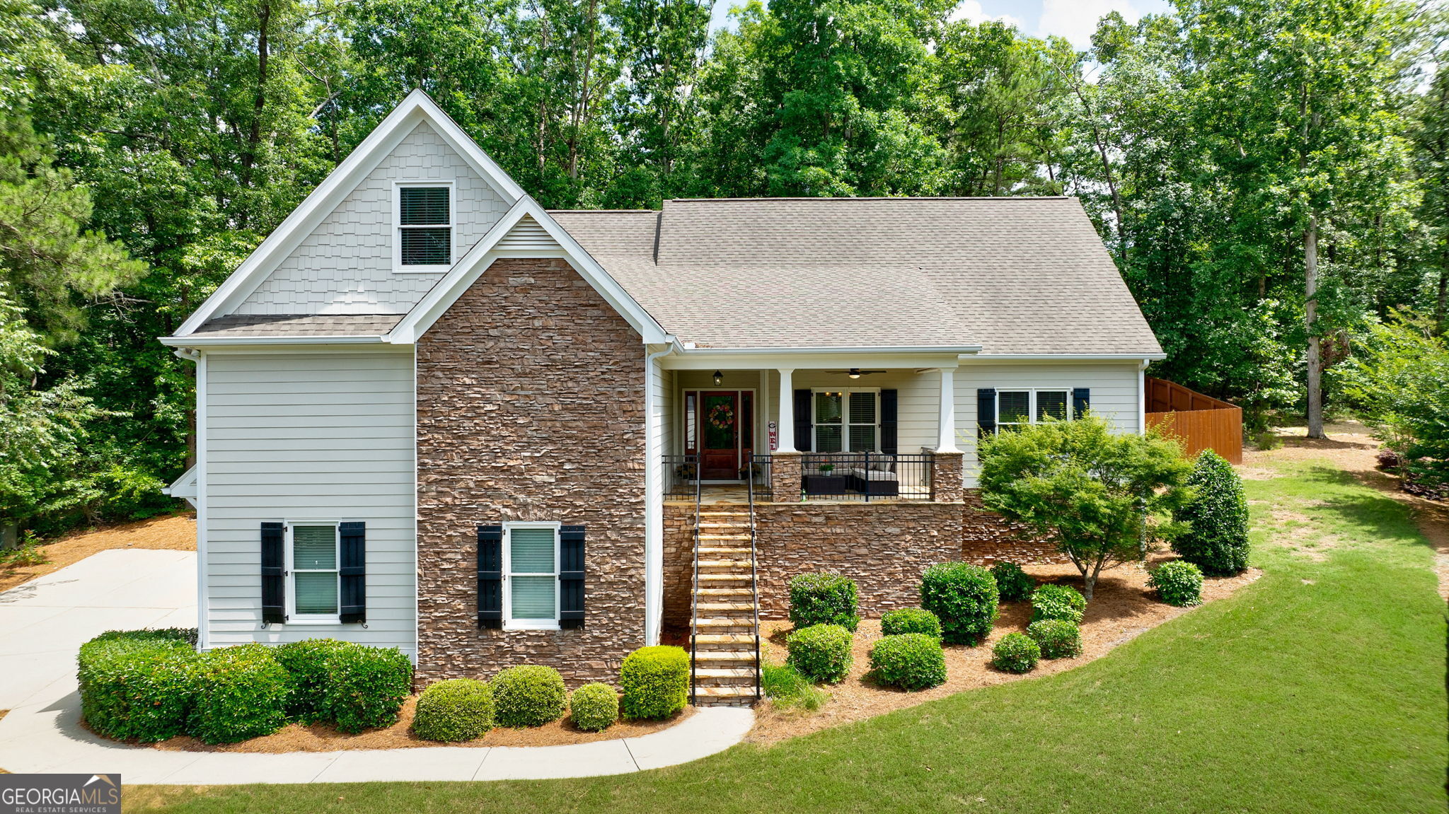 a aerial view of a house with yard and green space