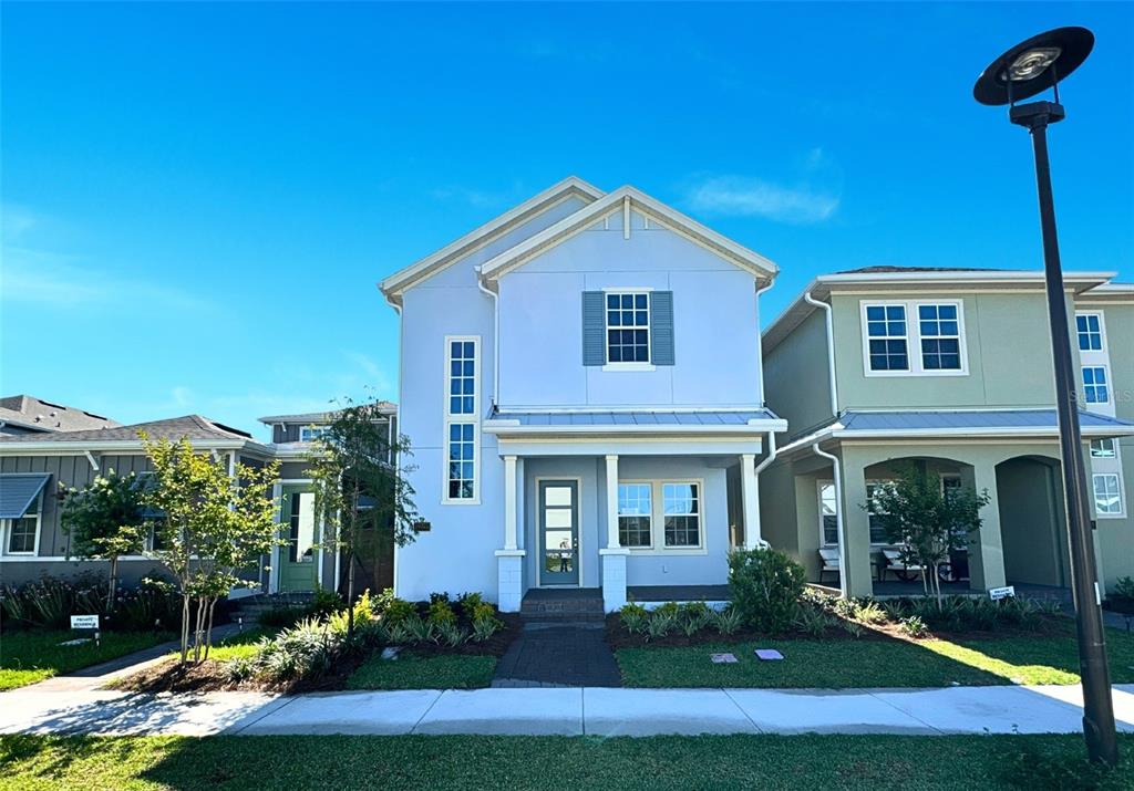 a front view of a house with yard and green space