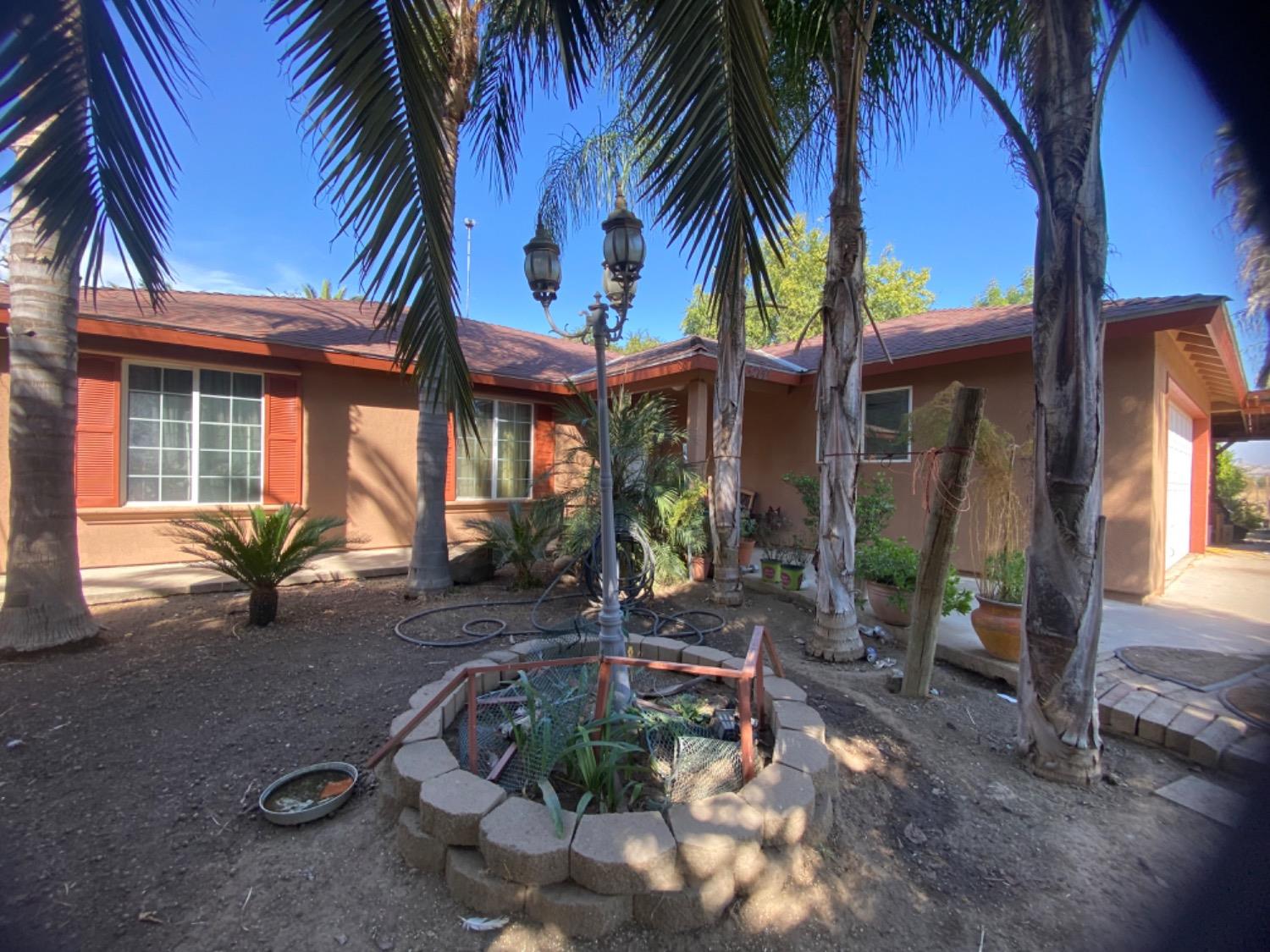 a view of a house with backyard porch and sitting area