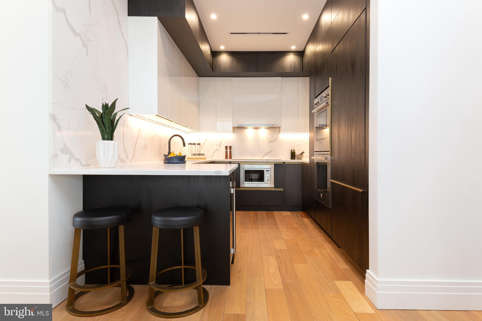 a kitchen with stainless steel appliances kitchen island granite countertop a sink and cabinets