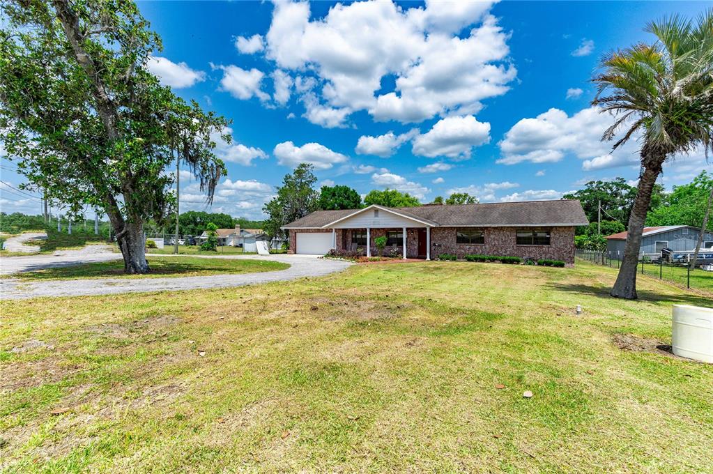 a front view of a house with a big yard