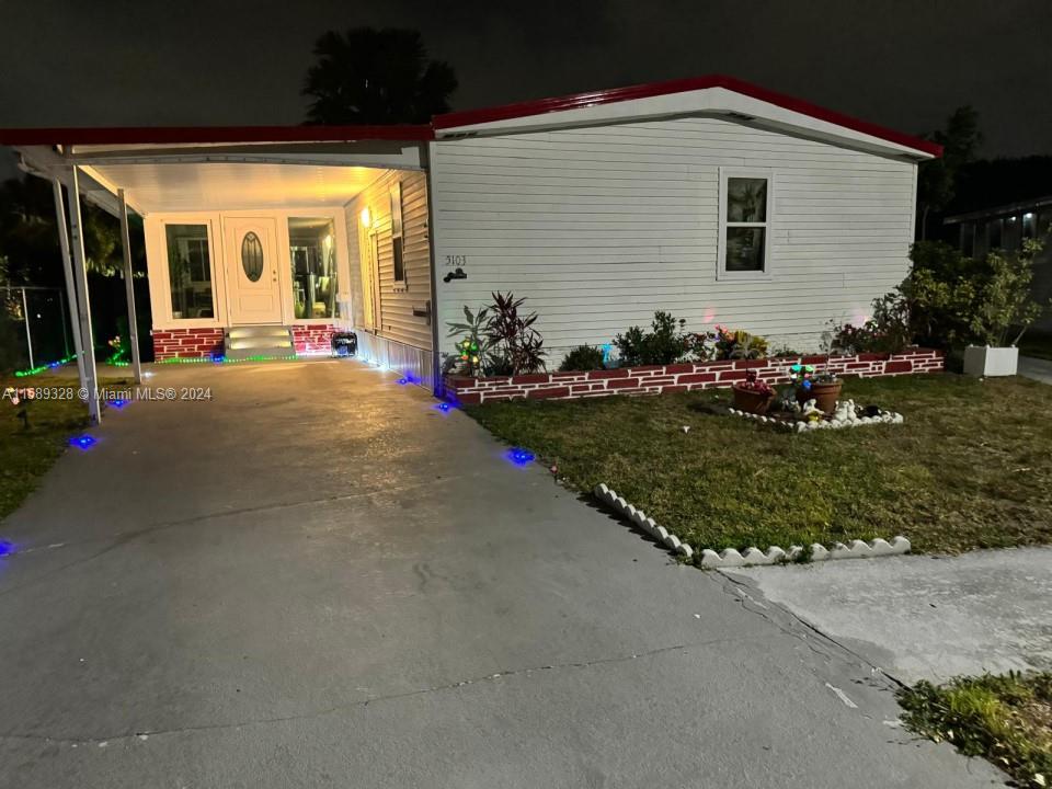 a front view of a house with a yard and outdoor seating