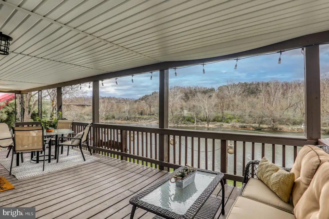 a balcony with furniture and wooden floor