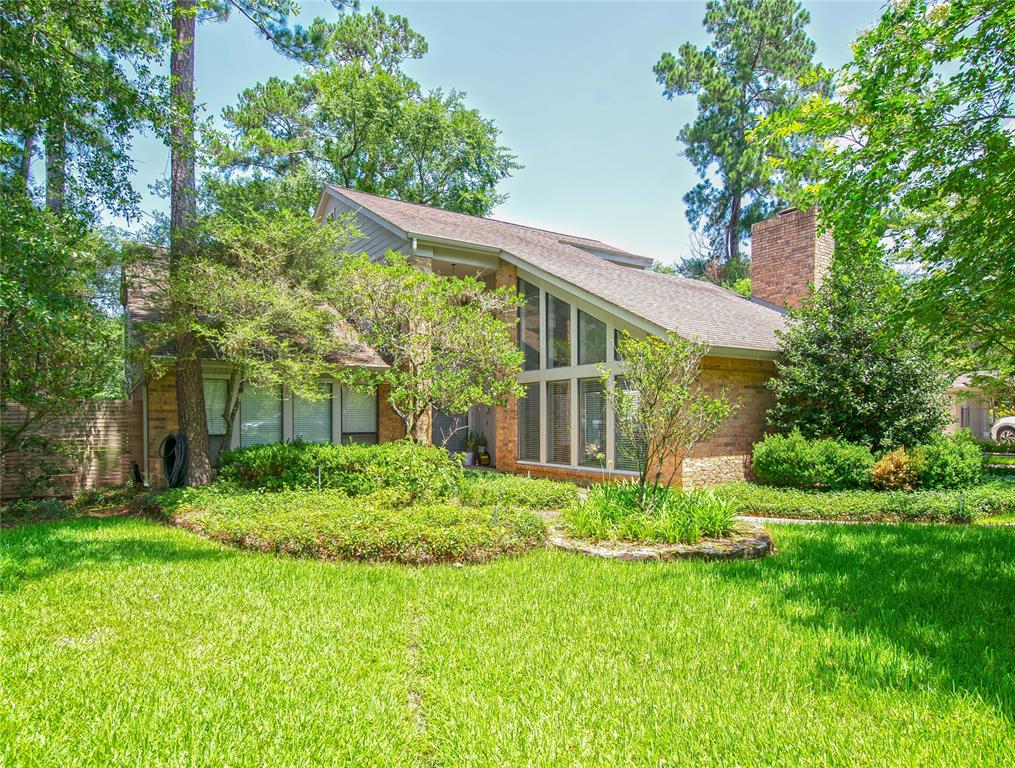 a view of a house with backyard sitting area and garden