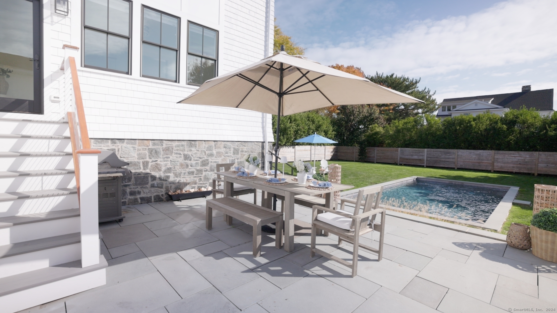 a view of house with backyard and furniture