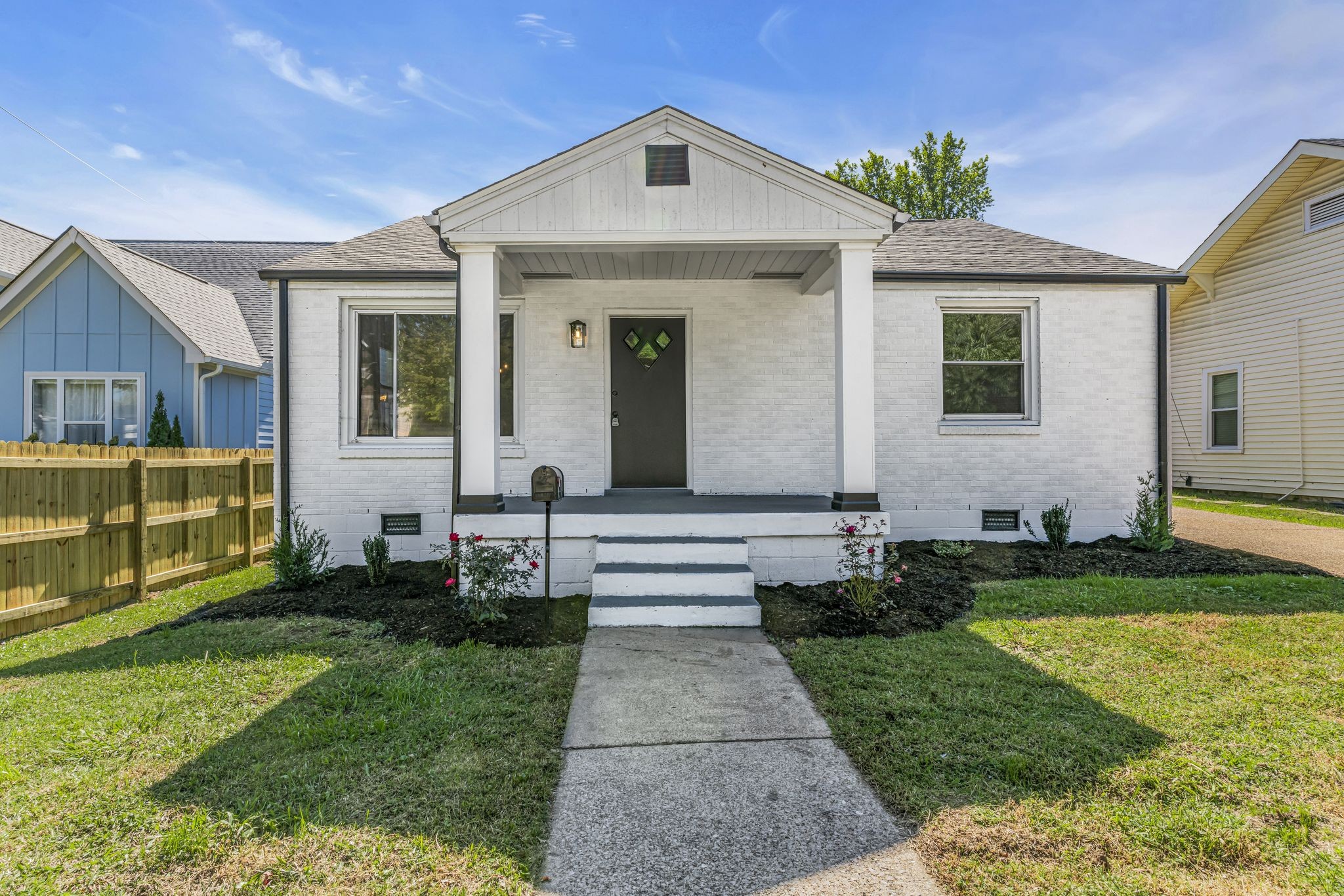 a front view of a house with garden