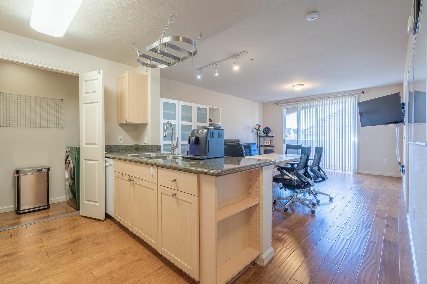 a kitchen with stainless steel appliances granite countertop a sink stove and wooden floor