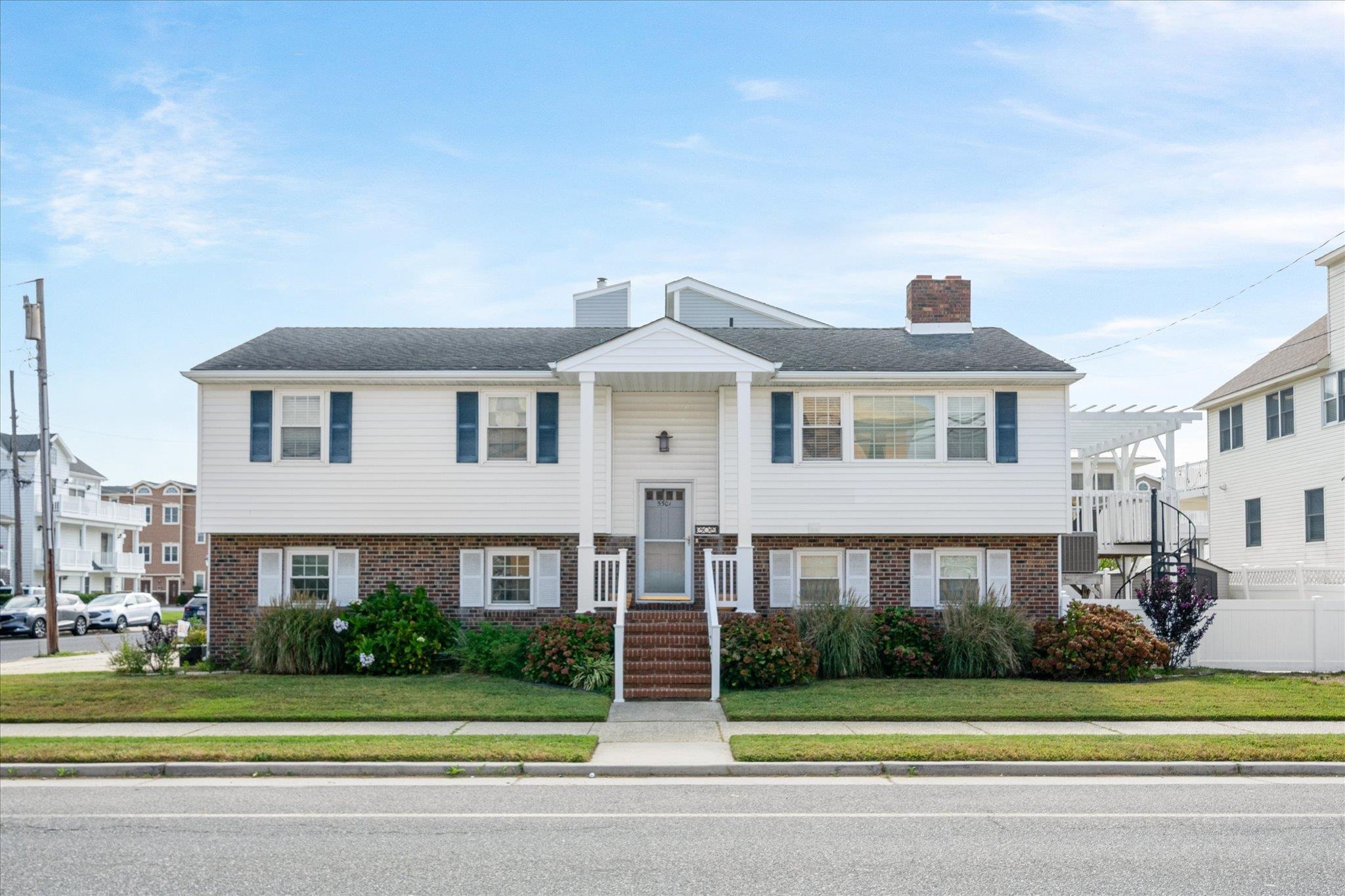 a front view of a residential apartment building with a yard