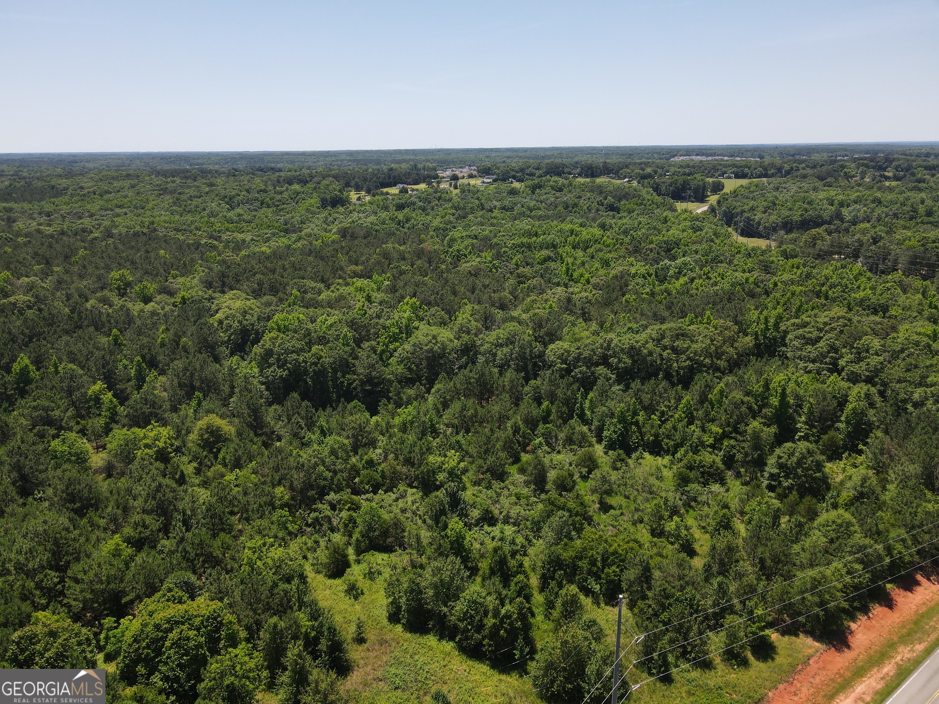 a view of a city with lush green forest