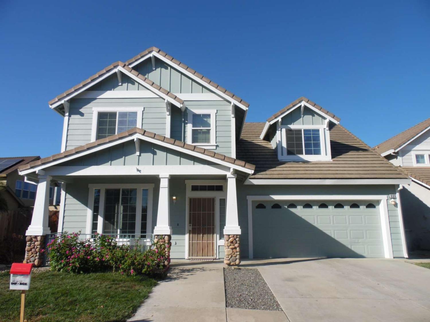 a view of a house with a yard and garage