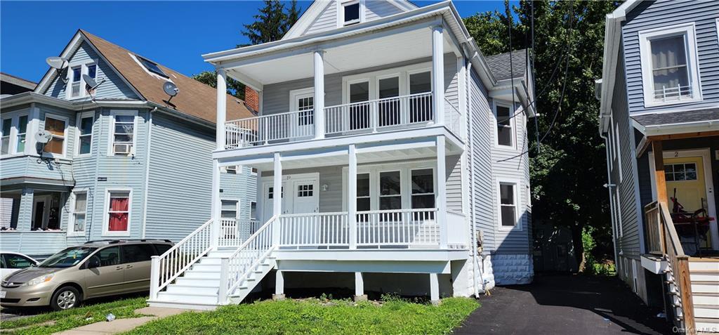 View of front of home featuring a balcony and a porch