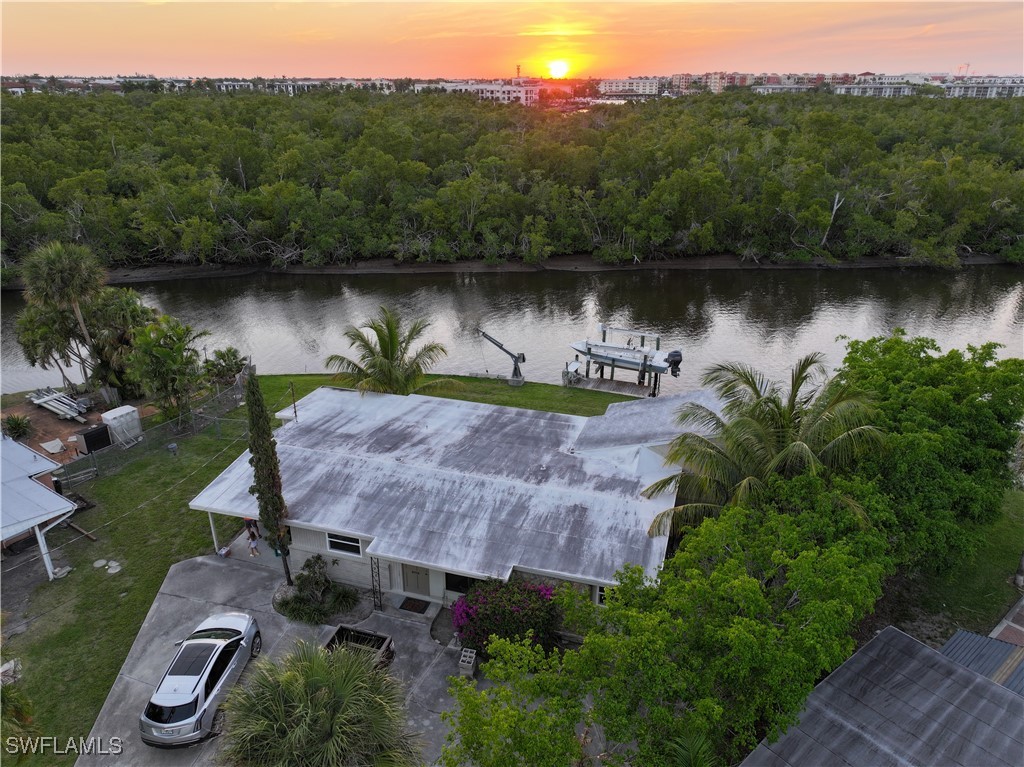 an aerial view of a house with a yard and lake view