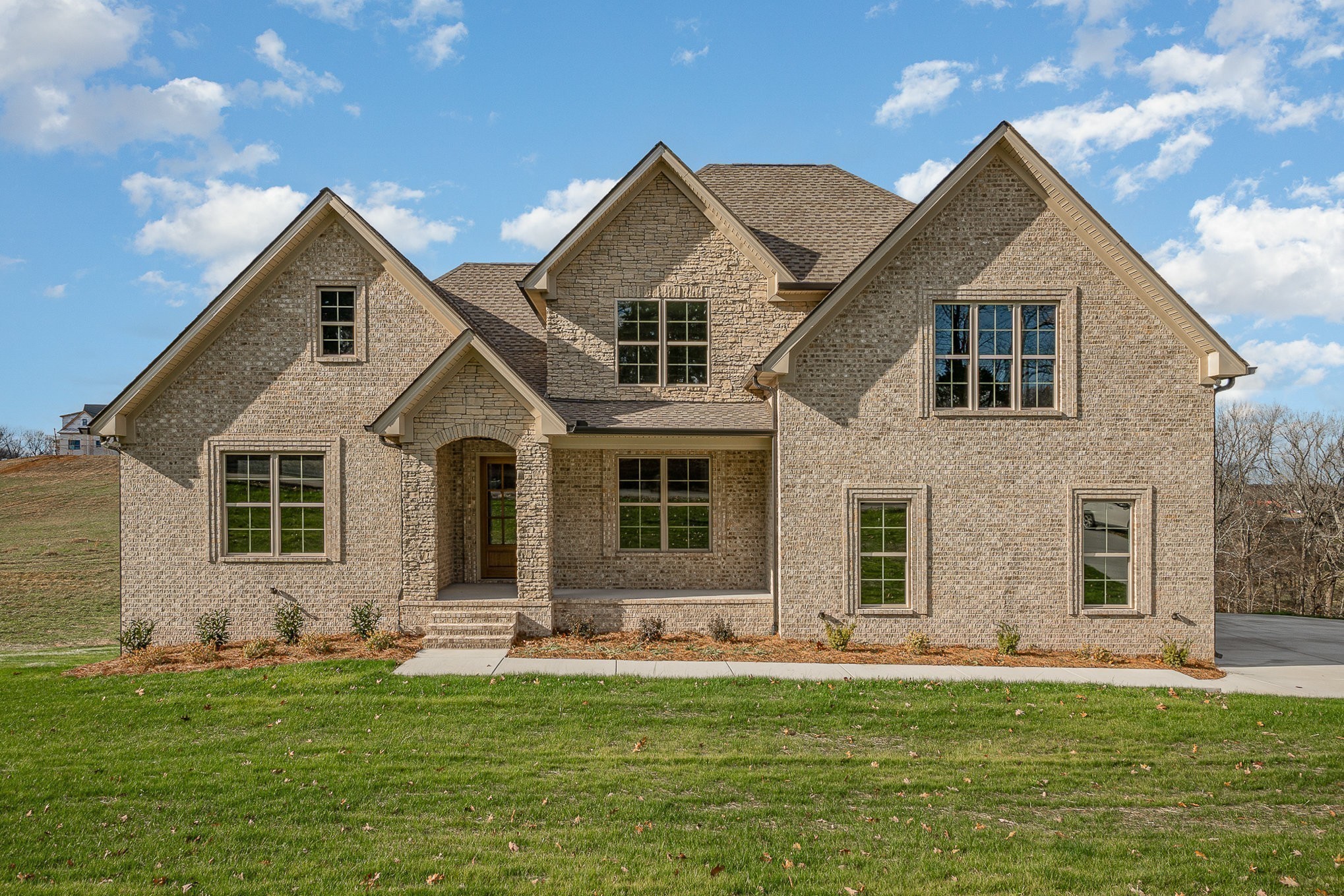 a front view of a house with a yard