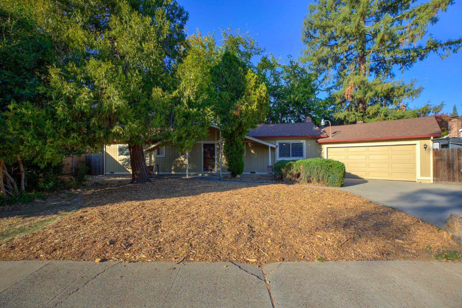 a front view of a house with a yard and a garage