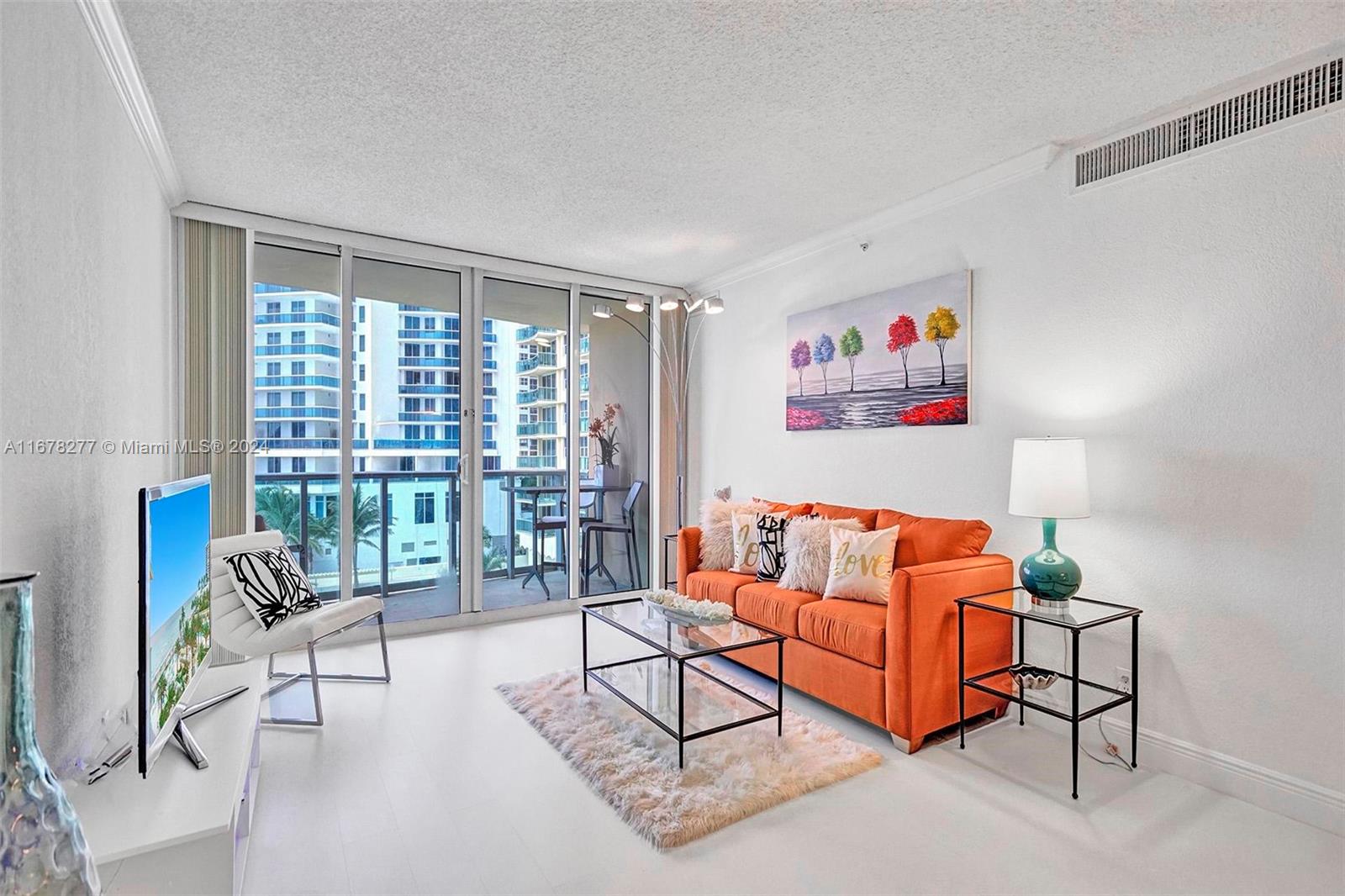 a living room with furniture a rug and a large window