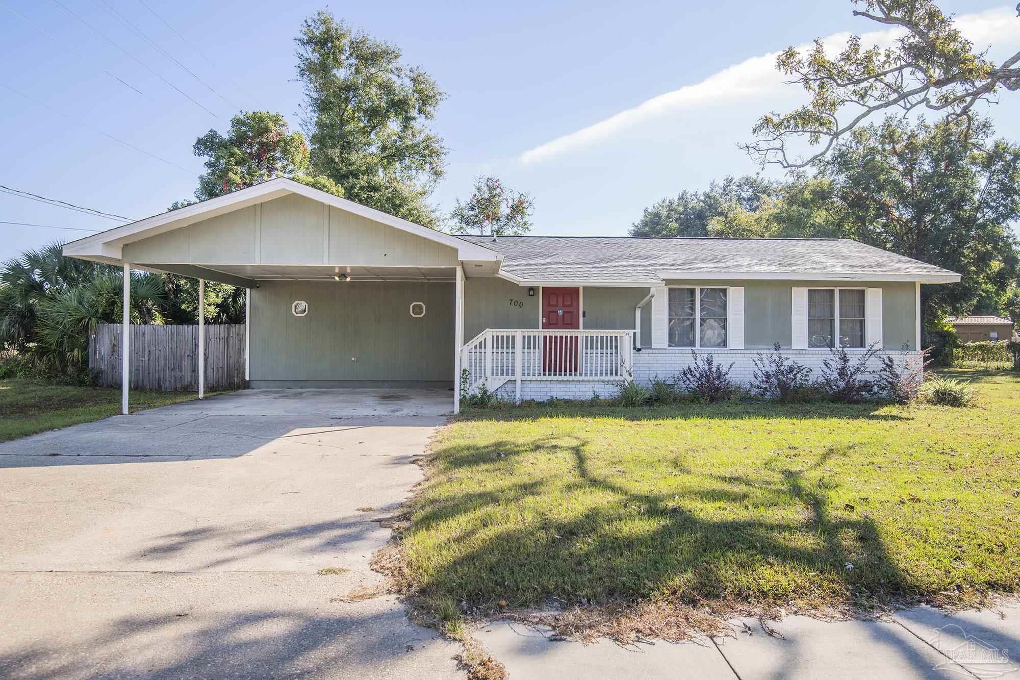 a front view of a house with a yard outdoor seating and garage