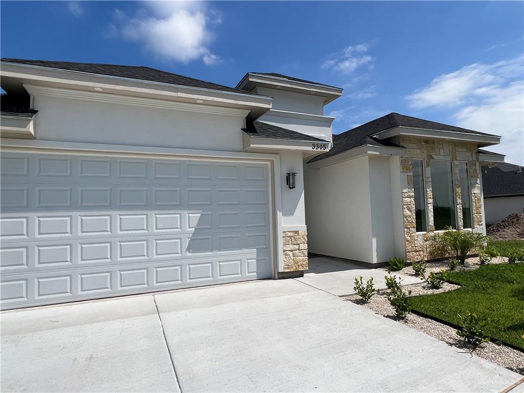 a front view of a house with garage