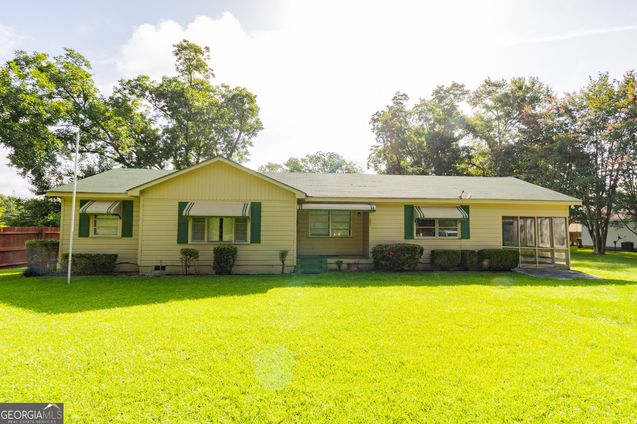 a view of a house with a yard and sitting area