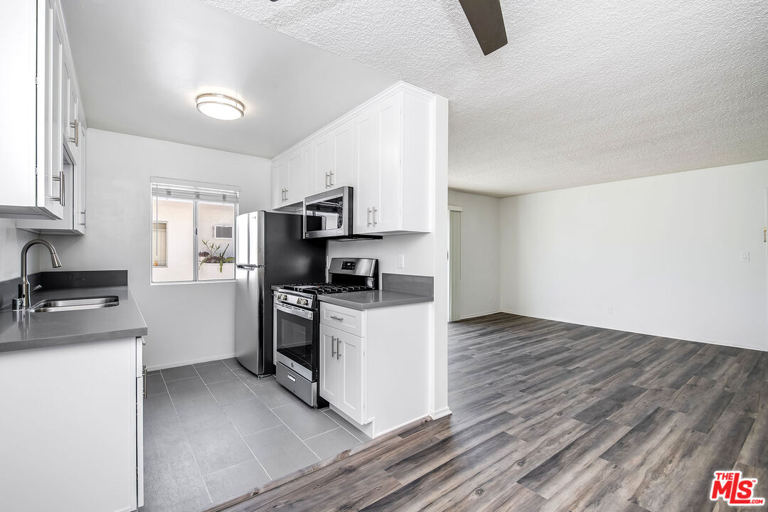 a kitchen with a stove a sink and a refrigerator