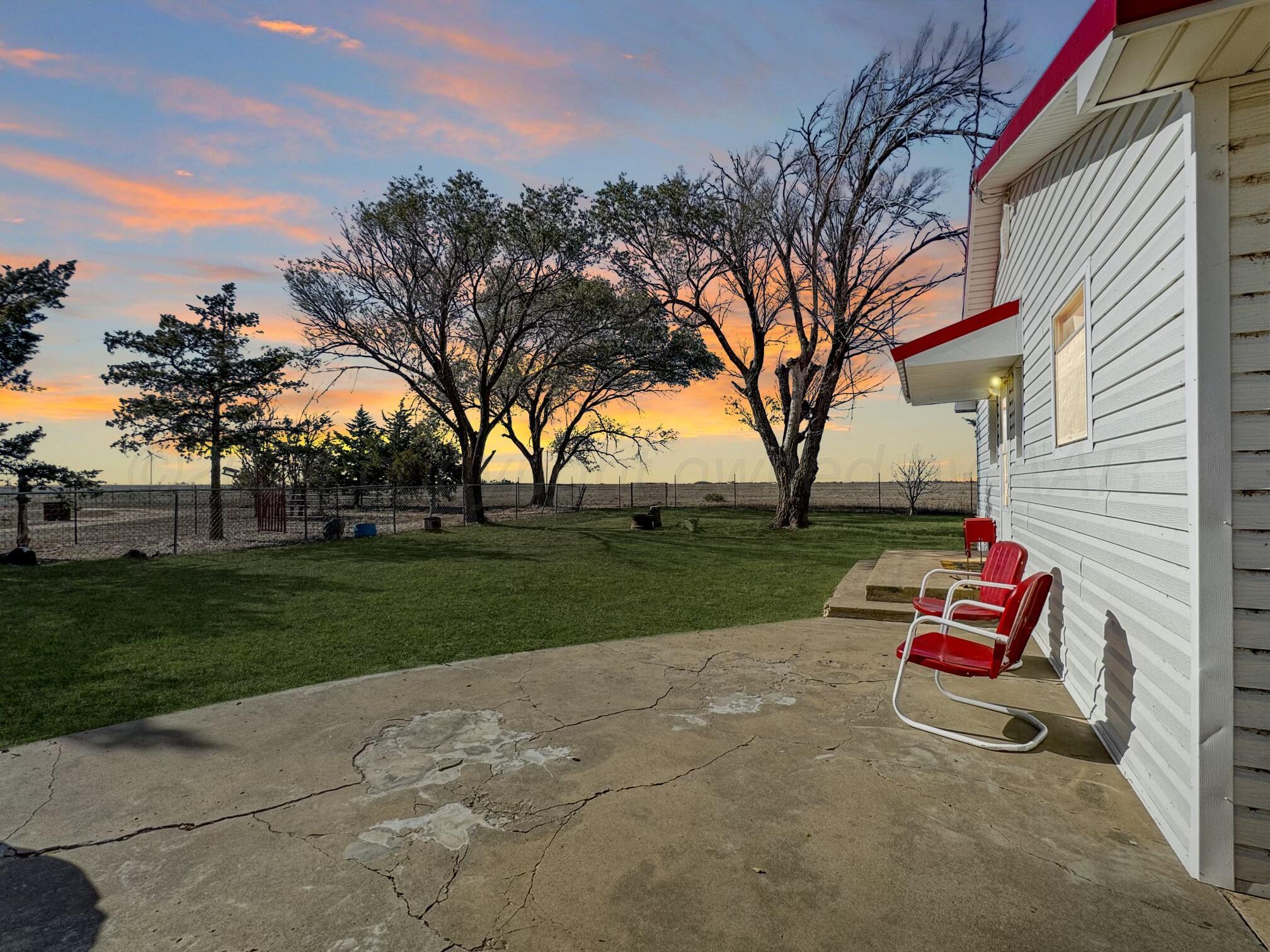 a backyard view of a house with trampoline