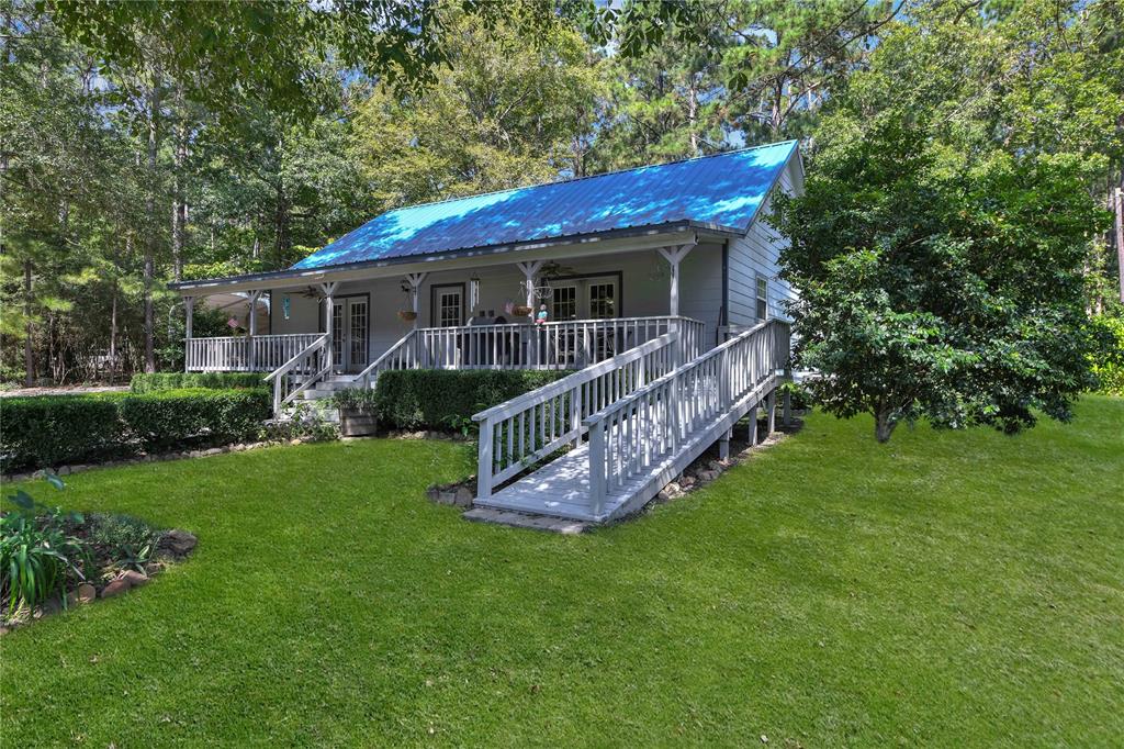 a view of a house with a yard deck and a garden