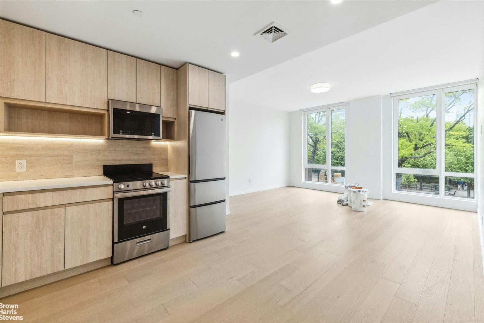 a kitchen with stainless steel appliances a stove sink and microwave