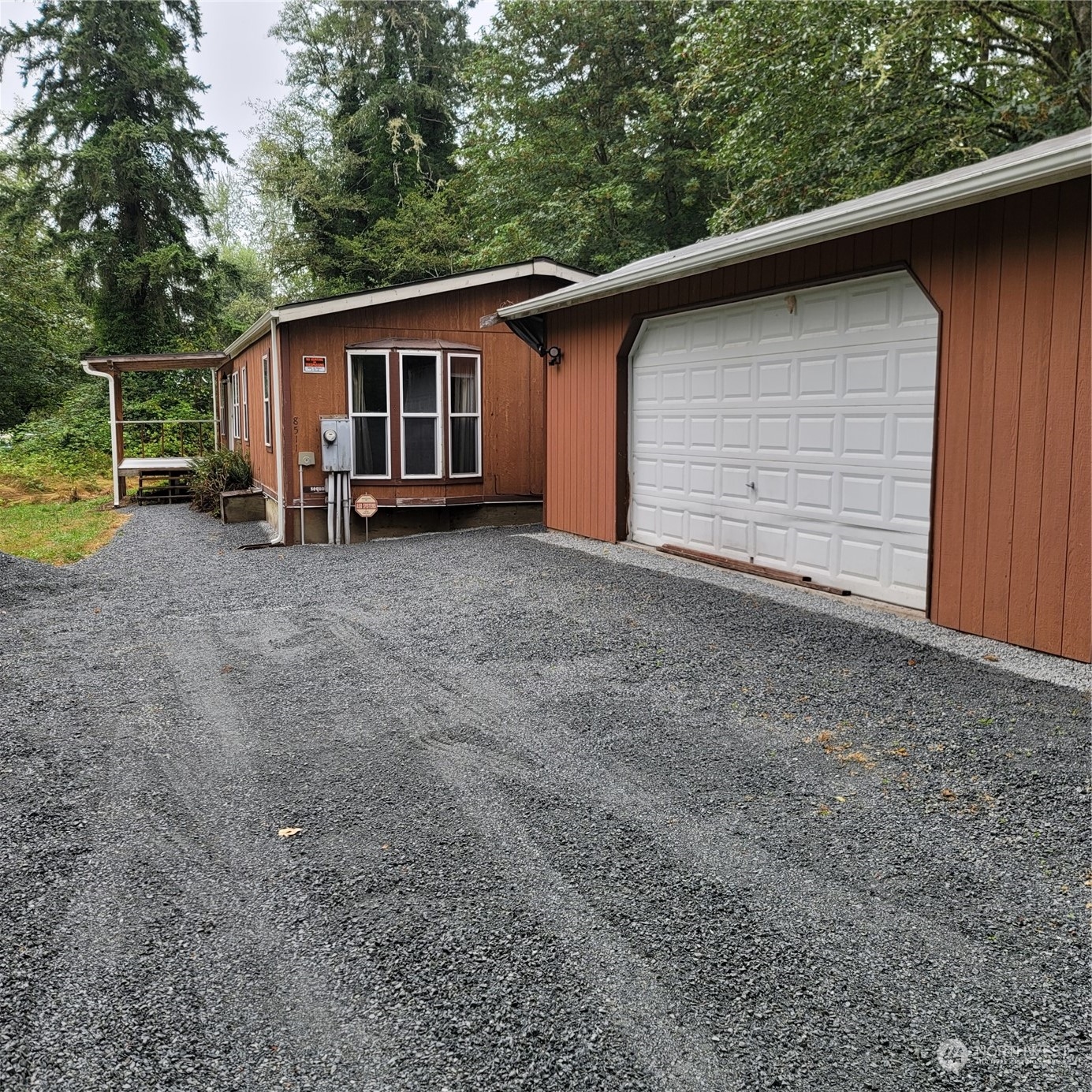 a view of a house with a backyard and garage