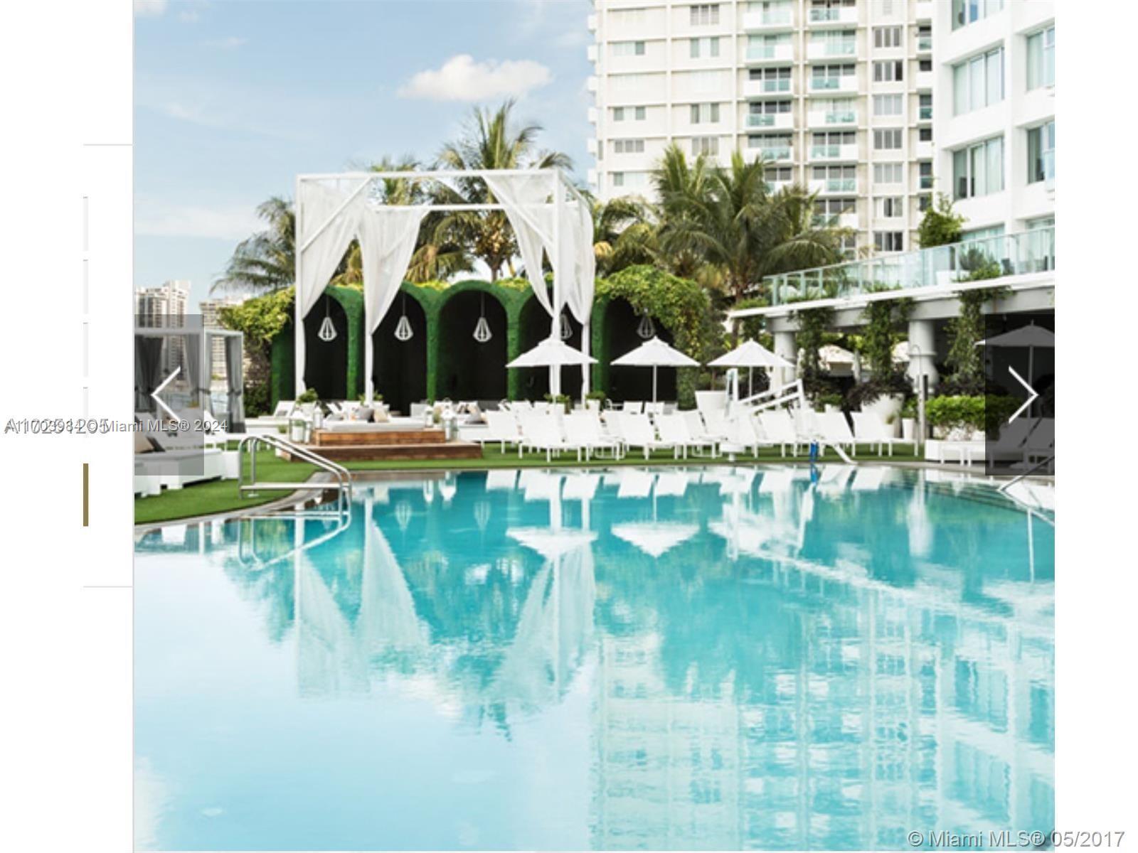 a view of swimming pool with a yard and seating area