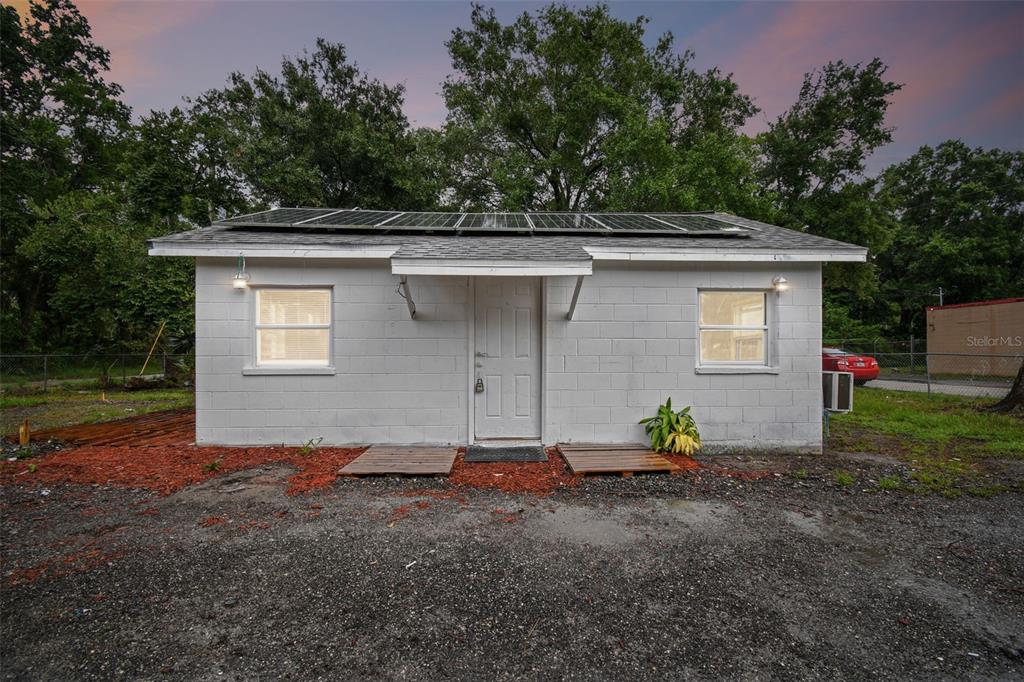 a view of house with backyard space and garden