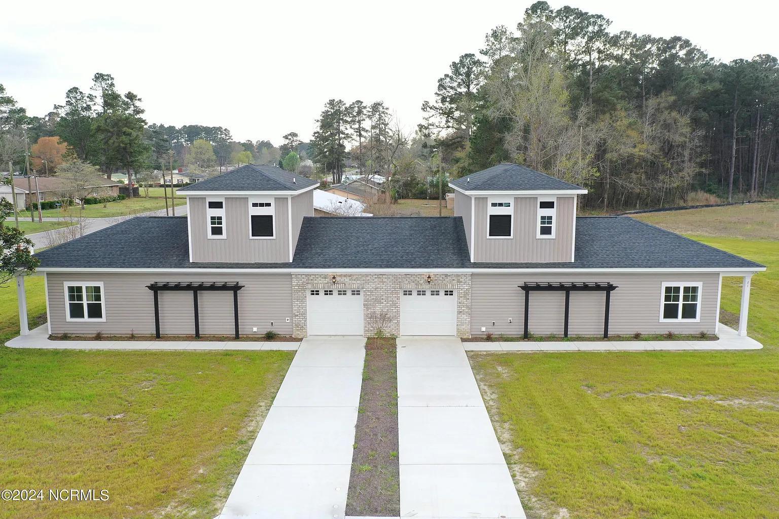 a white house that has a large pool in front of it