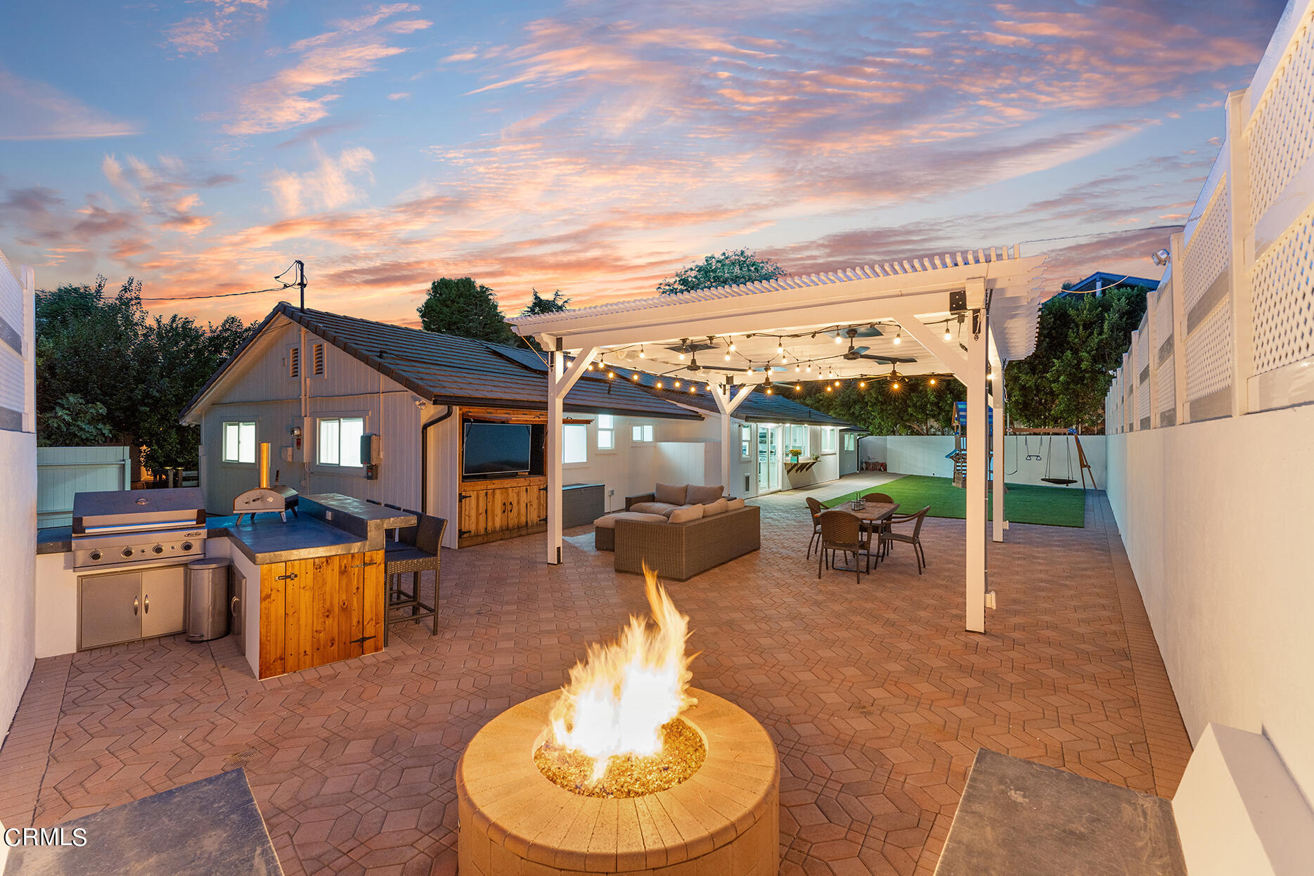 a view of a house with backyard porch and sitting area