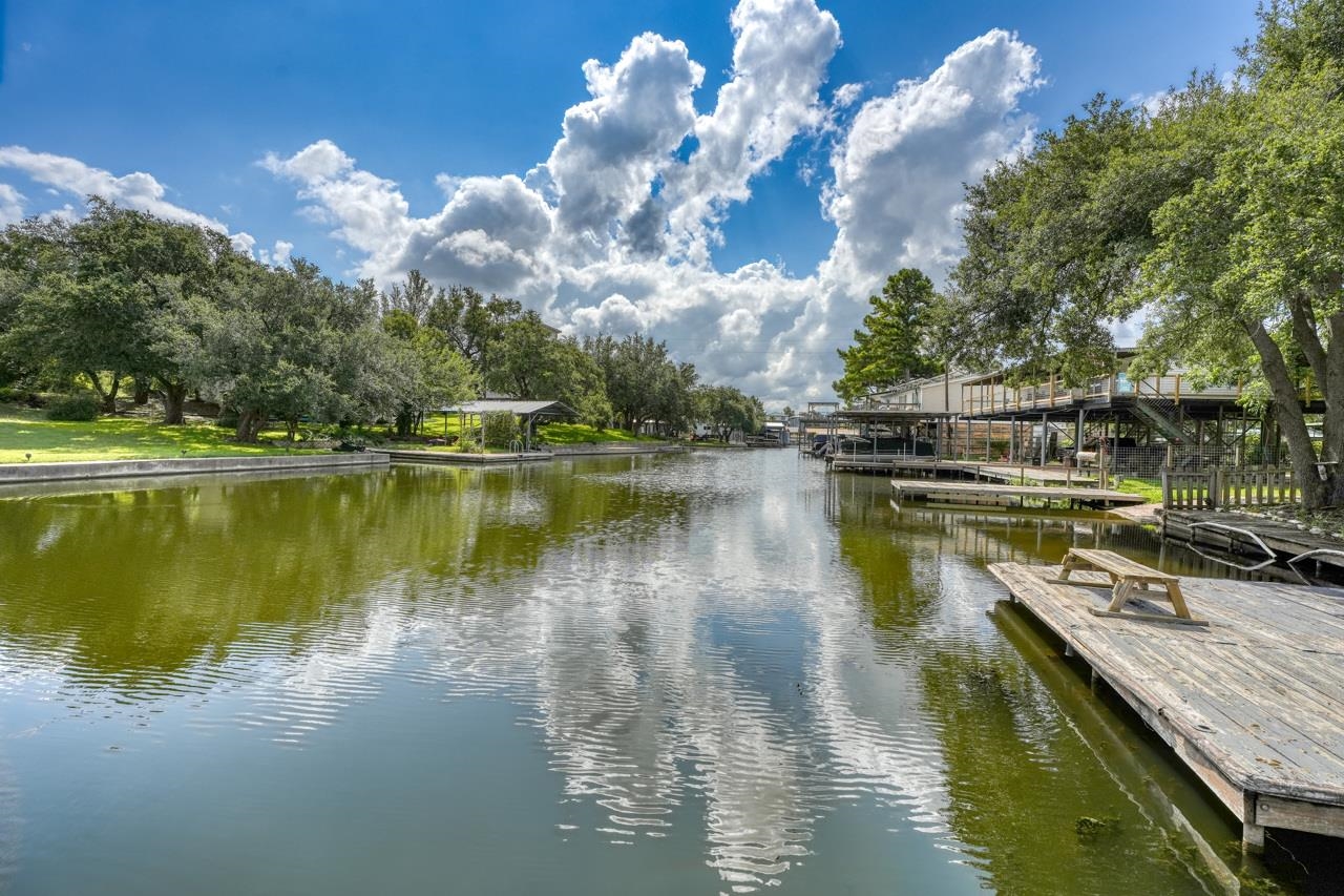 a view of a lake in between two chairs