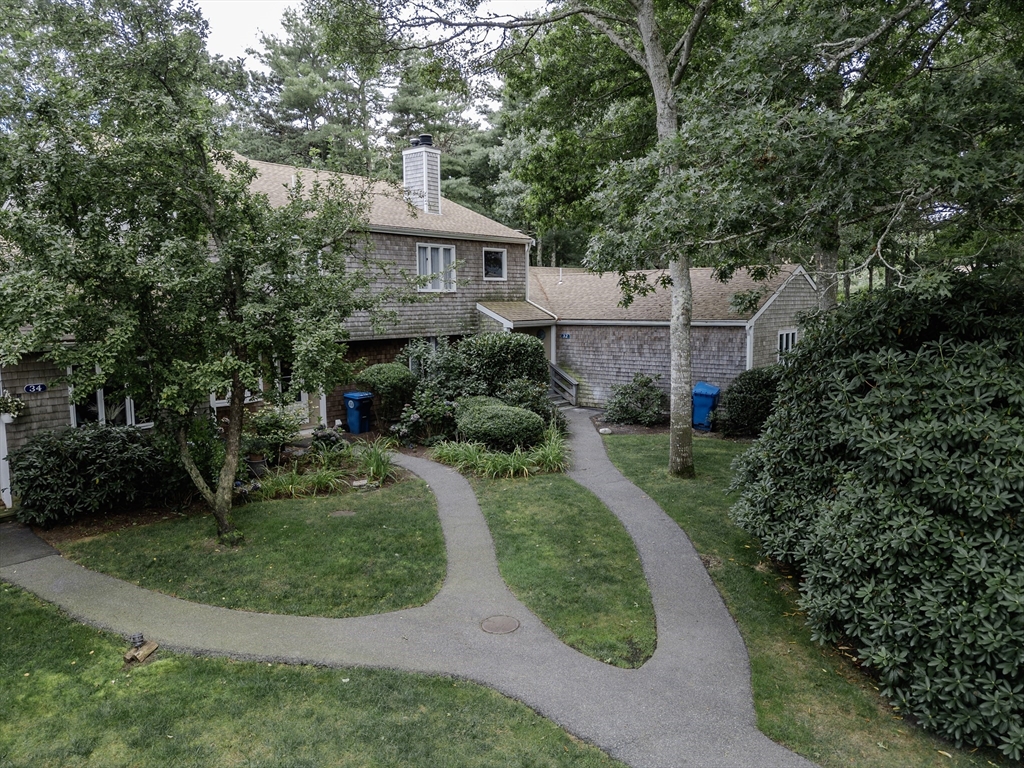 a aerial view of a house with a yard table and chairs