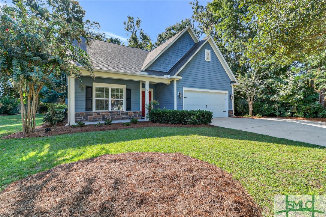 Featuring a striking red front door, elegant blue